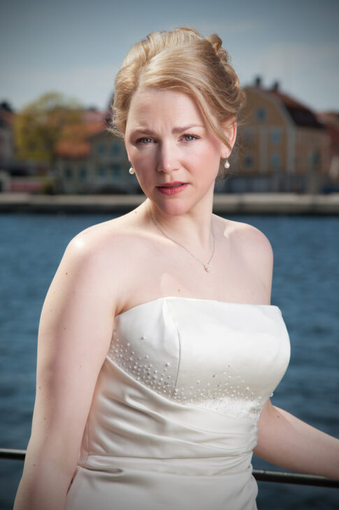 Portrait of a bride in a white wedding dress beside the waterfront in Karlskrona