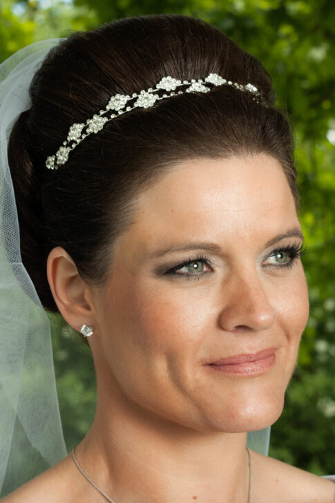 Close-up portrait of a bride wearing a wedding dress and jeweled headband