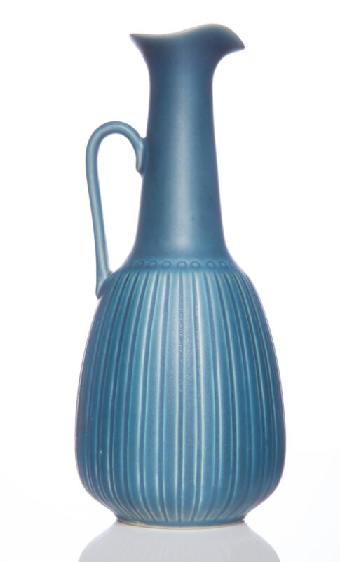 Blue ceramic vase photographed against a neutral background