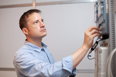 Network technician working with telecommunications equipment, photographed for Telenor