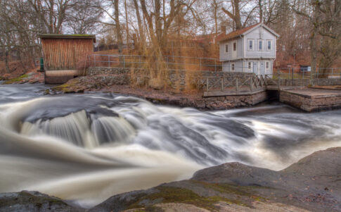 White historic house beside the rushing waters of Mörrumsån in Blekinge.