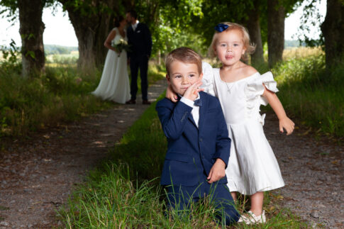 Young boy and girl dressed for a wedding walking outdoors